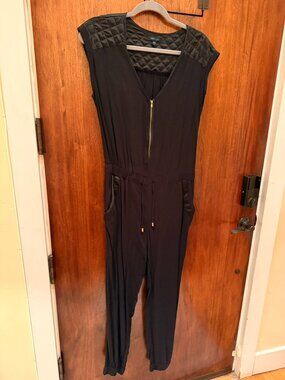 Cute, stylish black jumpsuit with quilted and satin detailing